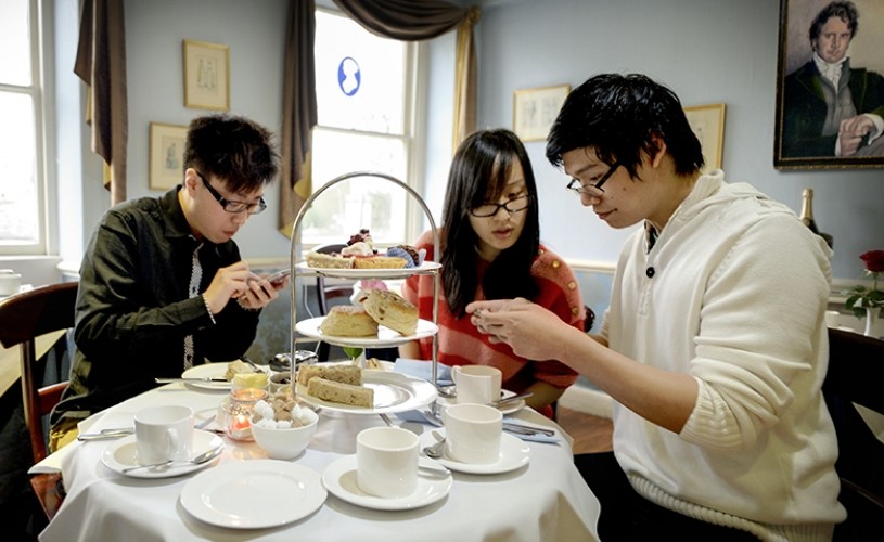 Three people having afternoon tea at the Jane Austen Centre's Regency Tea Room